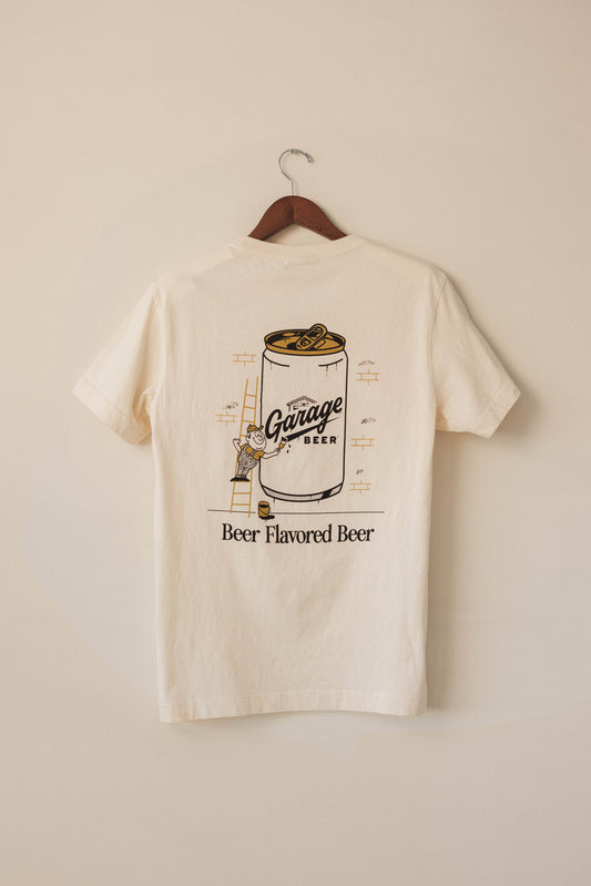 Beige t-shirt with graphic design of a beer can and text on a beige background