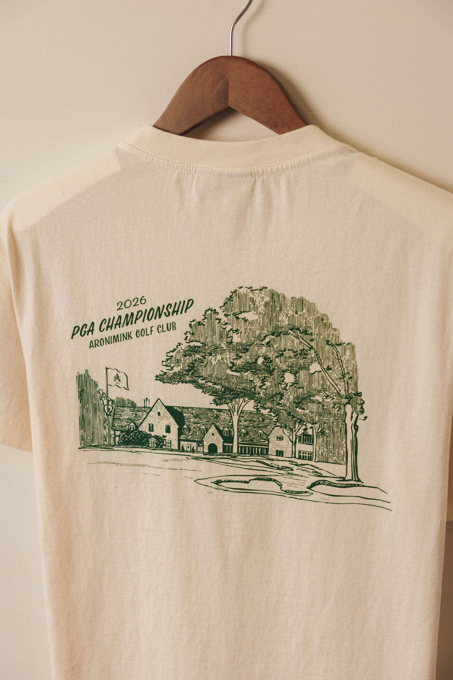 Ivory tee with green clubhouse graphic