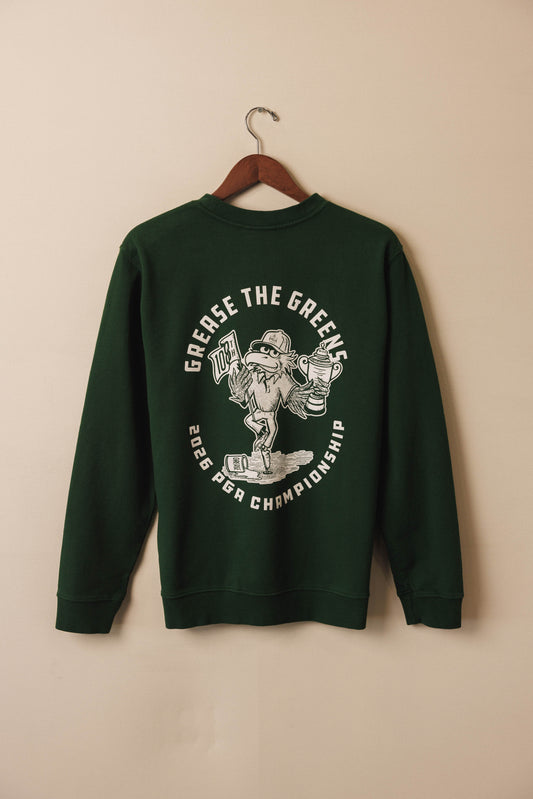 Green sweatshirt with graphic design on a beige background