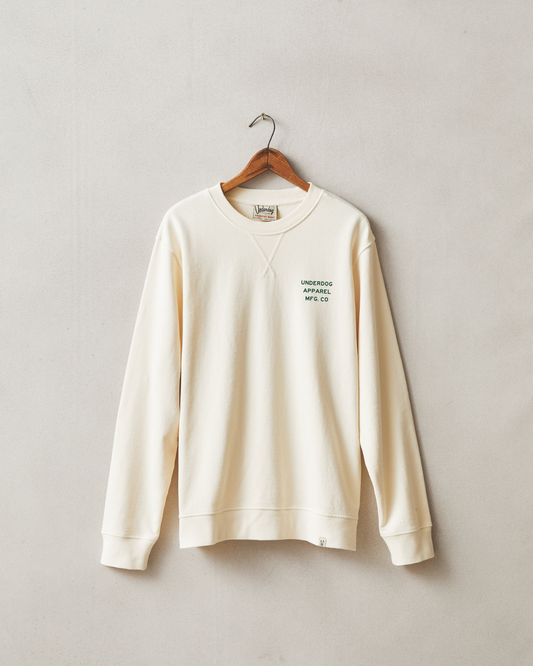 Ivory crewneck sweatshirt hanging with green embroidered text