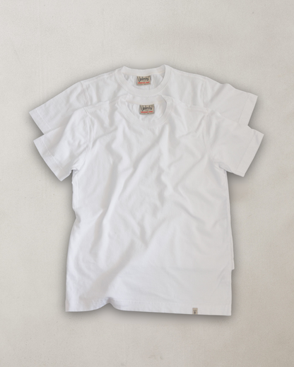 White t-shirt with a brand logo on a light gray background
