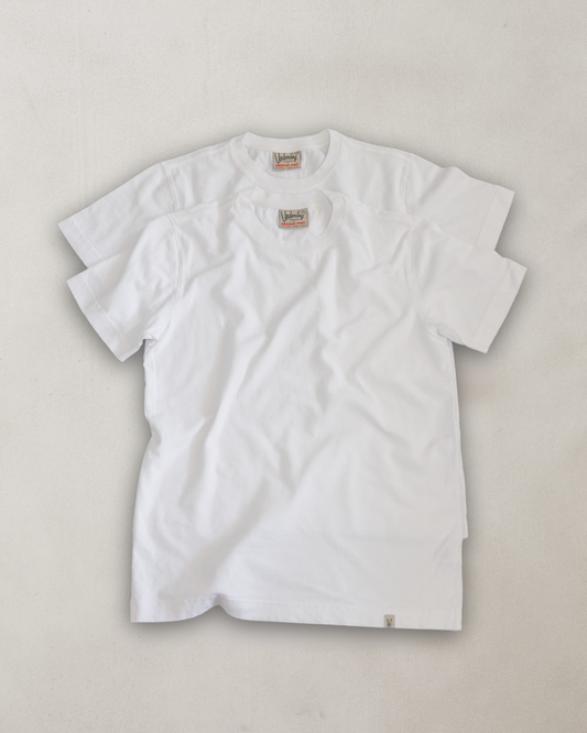 White t-shirt with a brand logo on a light gray background