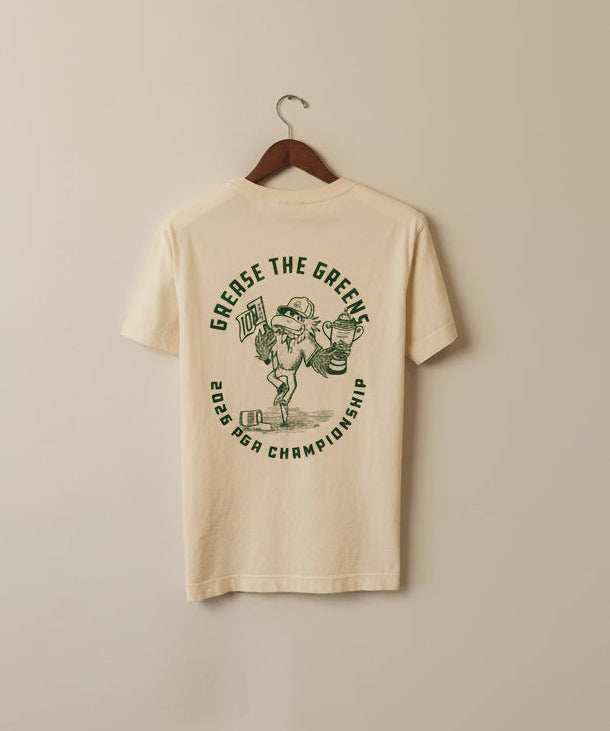 Beige t-shirt with graphic design and text on a beige wall