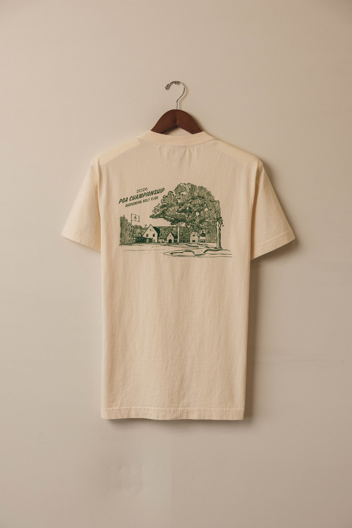 Ivory tee with green clubhouse graphic