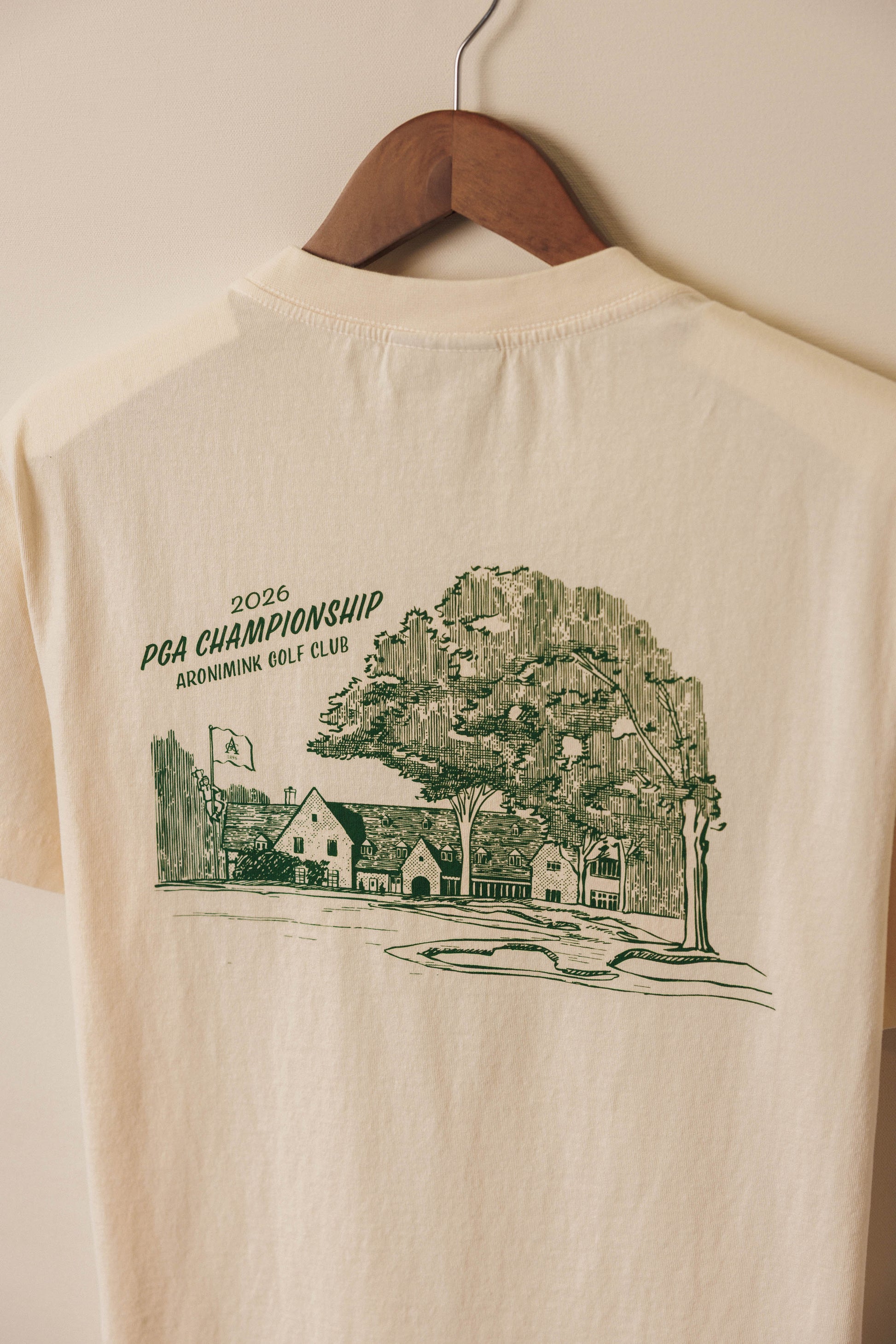 Ivory tee with green clubhouse graphic
