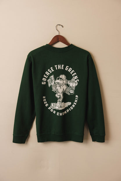 Green sweatshirt with graphic design on a beige background