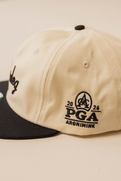 Beige cap with black logo and text on a beige background