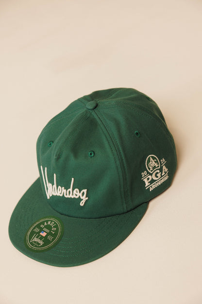 Green cap with embroidered logos on a beige background