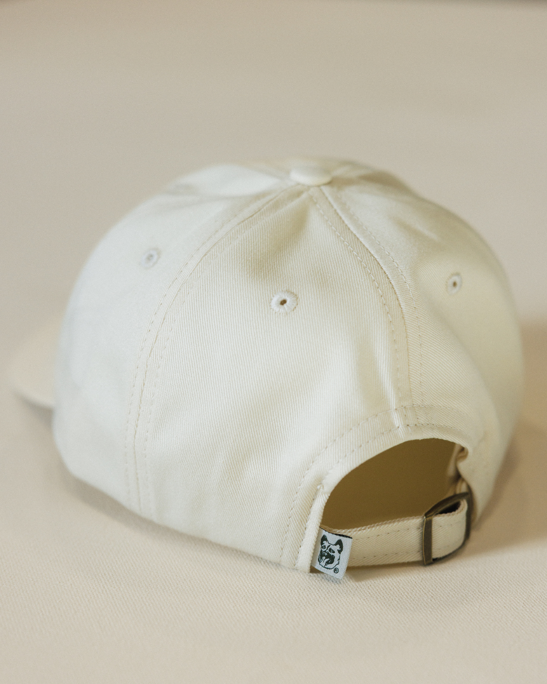 Beige baseball cap on a beige background